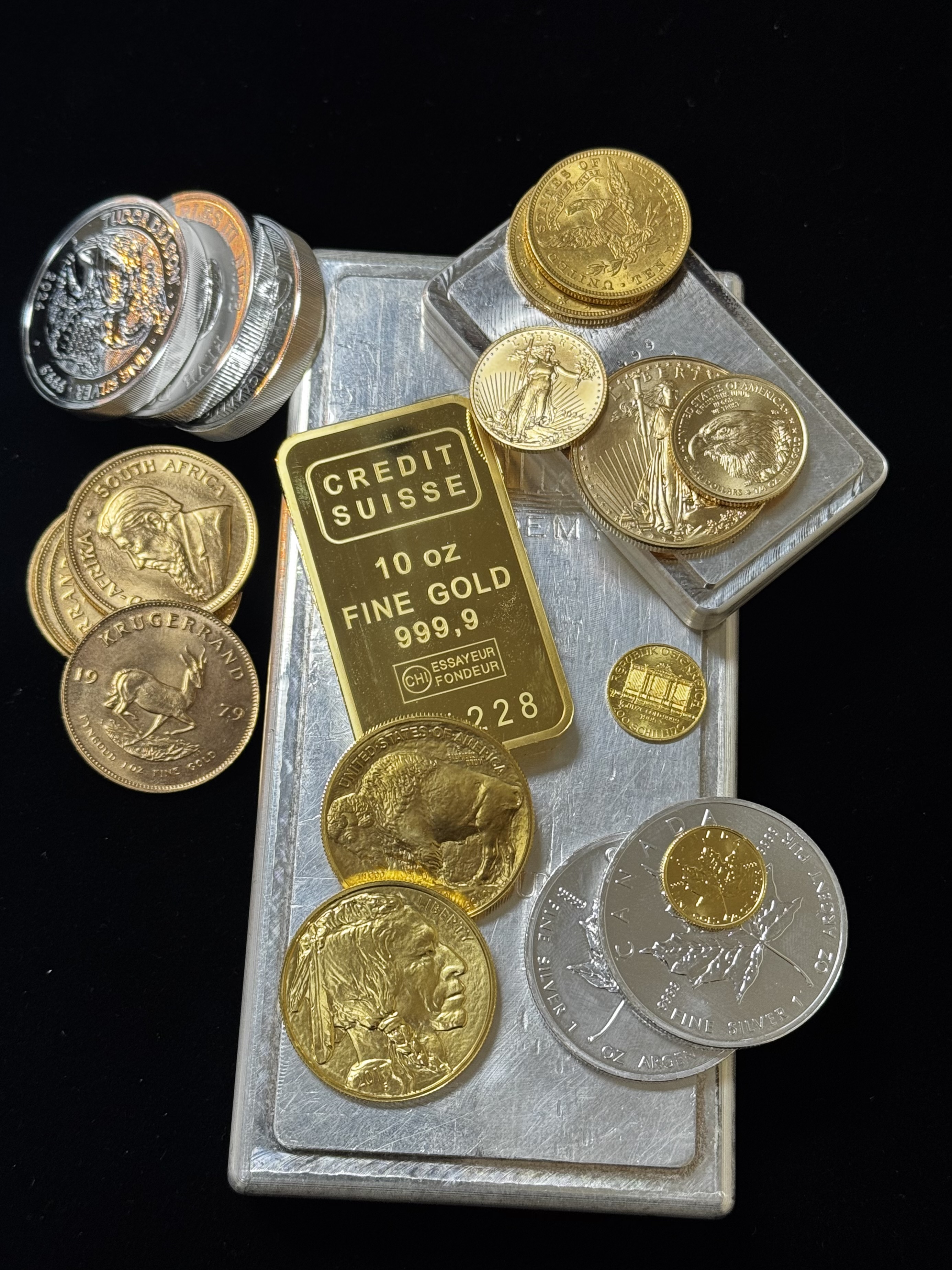 Gold and silver coins with precious-metal bars