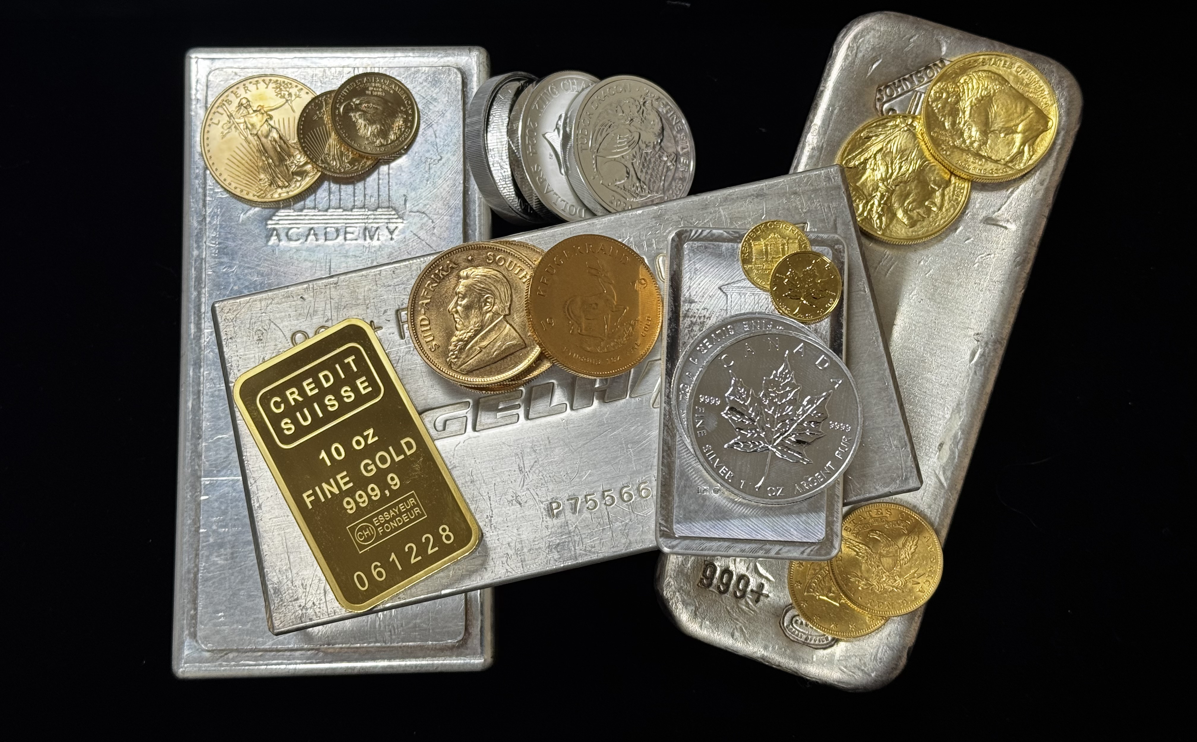 Gold and silver bars arranged with gold and silver coins